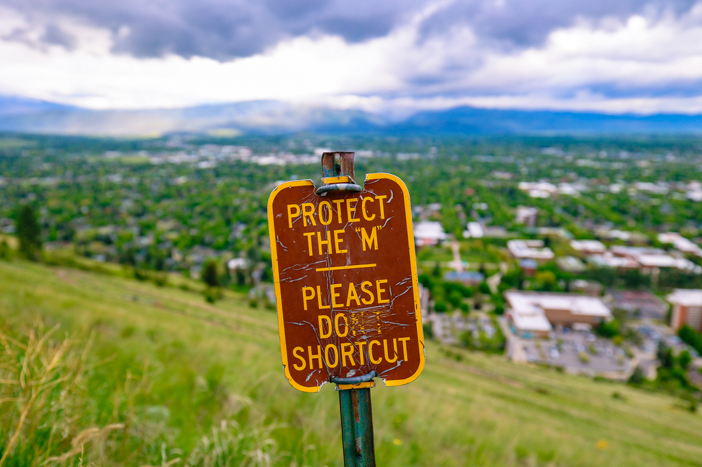 Please prevent erosion and leave no trace. Sign urging people to protect The M trail in Missoula, Montana of University of Montana campus