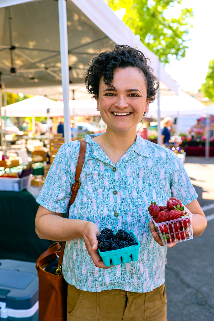 Woman holding berries at the Chico certified farmers market in California